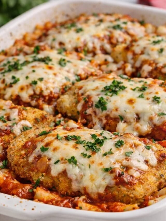 Ragu Chicken Parm Recipe – Easy Baked Chicken Parmesan with Cheesy Pasta 9 Ragu chicken parm recipe baked in a white casserole dish with crispy breaded chicken, melted mozzarella and Parmesan cheese, tomato sauce, and pasta